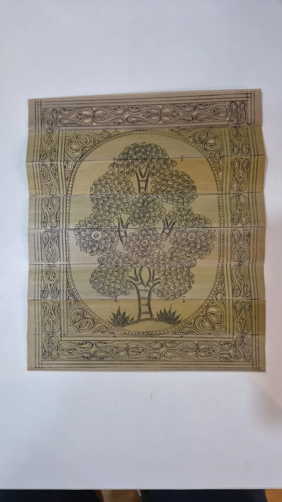 Detail of a tree motif on a Talapatra palm-leaf artwork